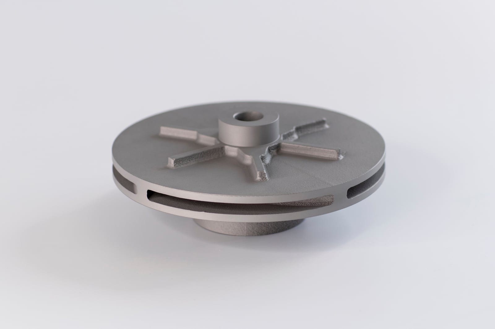 Support-free IN718 nickel alloy pump impeller showing internal flow passages, printed on an EOS M 400-4