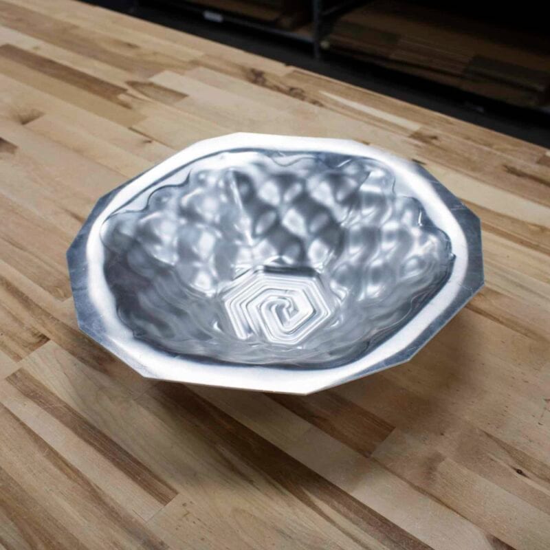 Faceted aluminum bowl with a textured, dimpled interior formed on the Figur G15