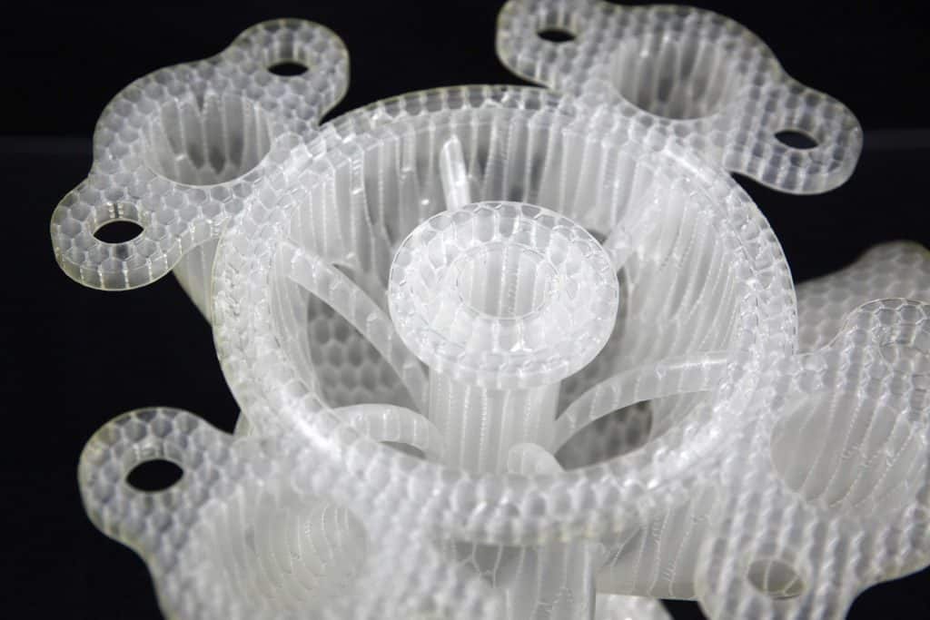 Clear SLA-printed lattice valve components showing fine internal detail