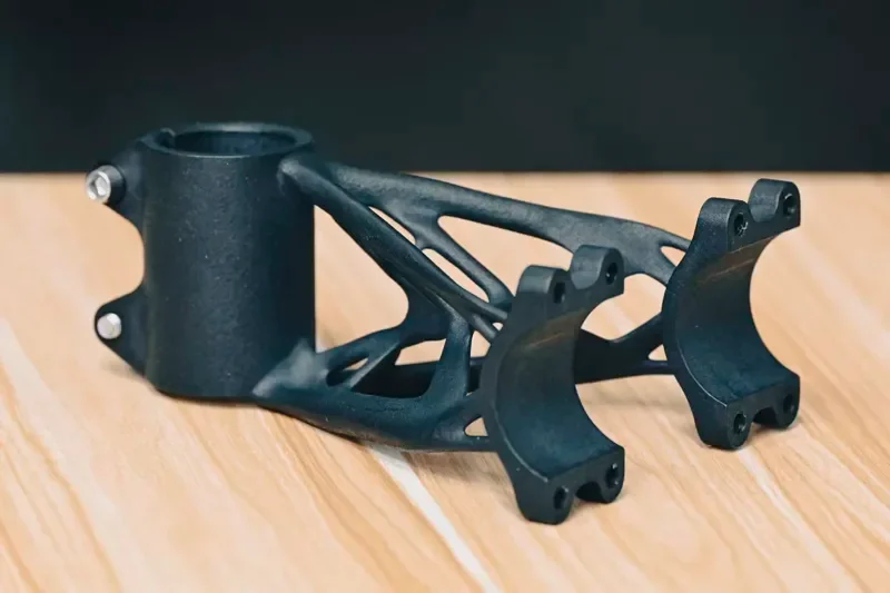 Topology-optimized SLS nylon bike stem from the powder bed