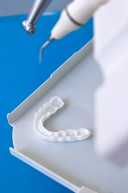 White nylon dental splint printed with SLS on a dental work tray