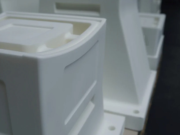 Close-up of a white SLS nylon housing showing crisp edges and recessed details