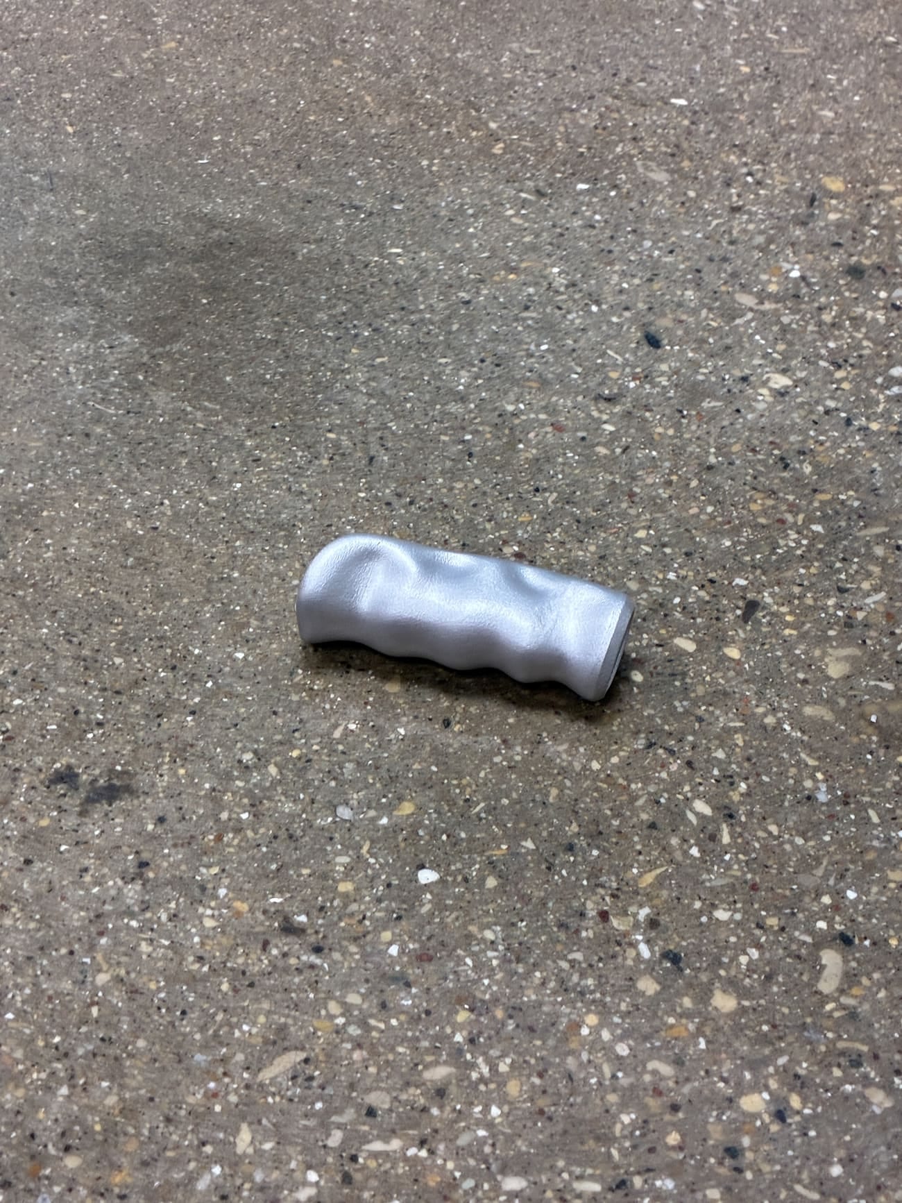 The handbrake grip showing its hand-shaped organic form