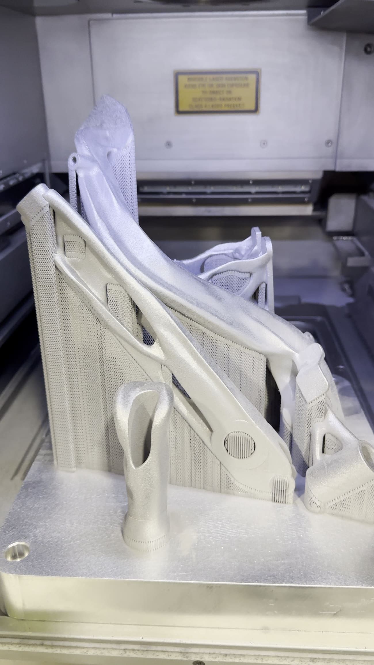 The full build plate of parts as printed with support structures