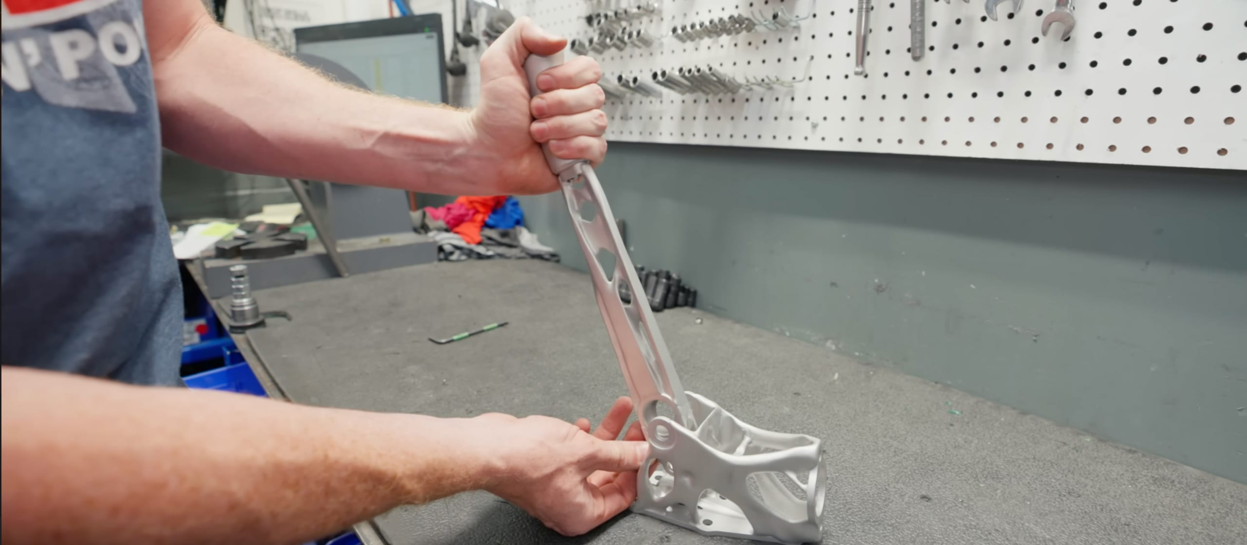 AlSi10Mg DMLS handbrake and clutch pedal parts on the build plate at Evology Manufacturing
