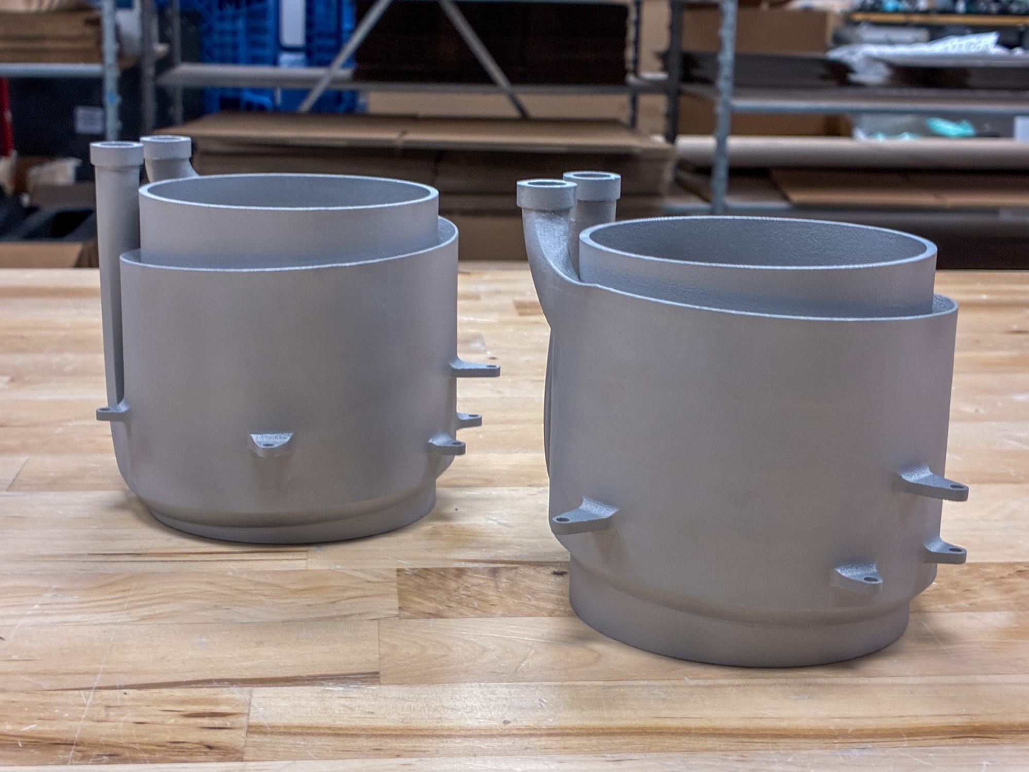 Two finished DMLS aluminum cooling sleeves on the bench
