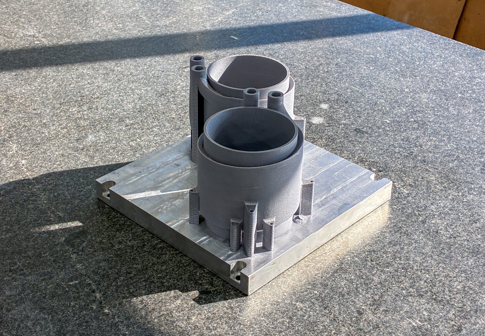 As-printed cooling sleeve showing the helical exterior and support pillars