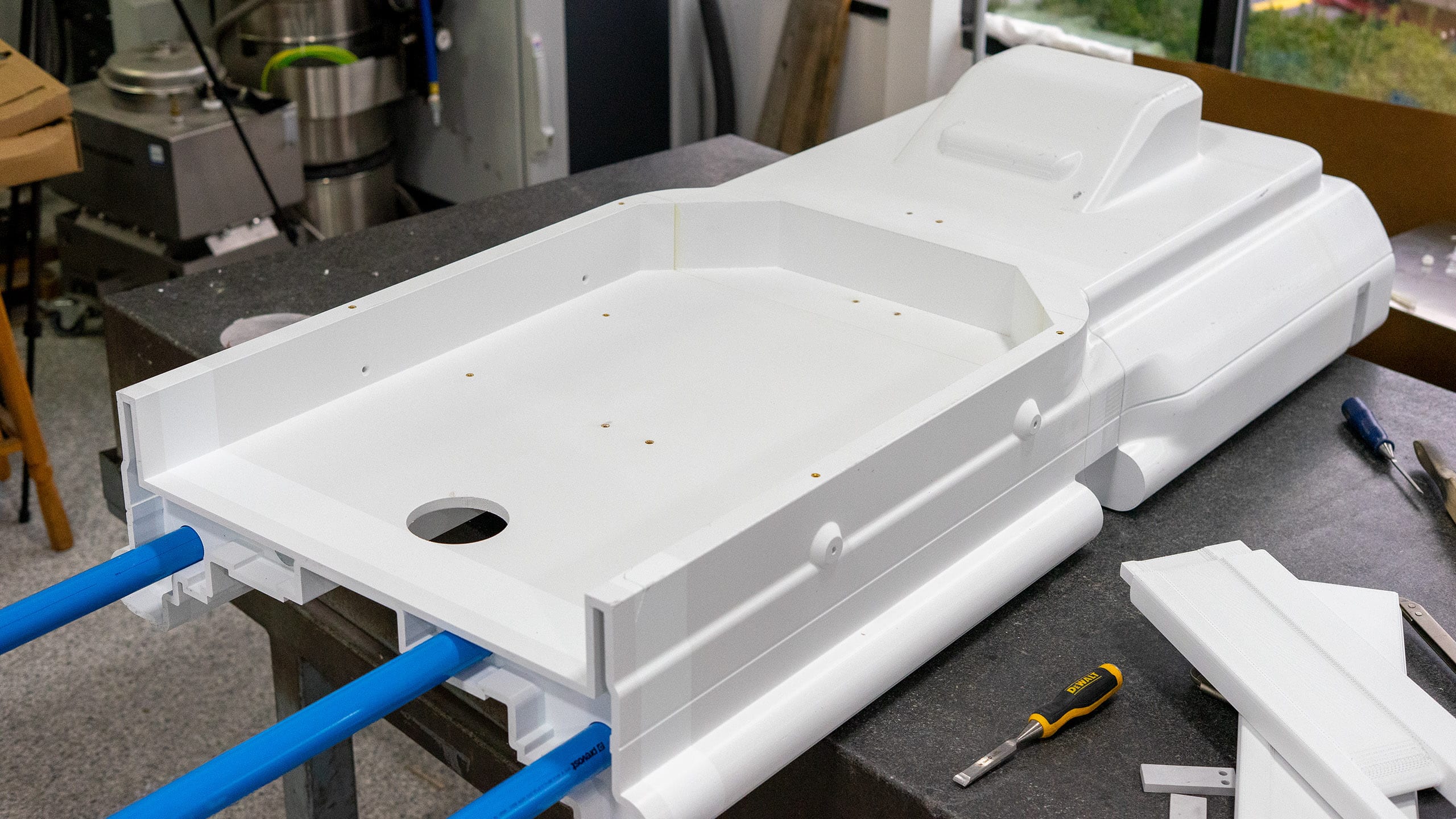 Large white printed ASA sections of an MRI table staged on a workbench