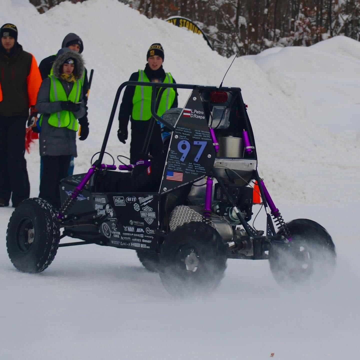 MSOE Raider Racing Baja car number 97 racing across snow during a winter competition