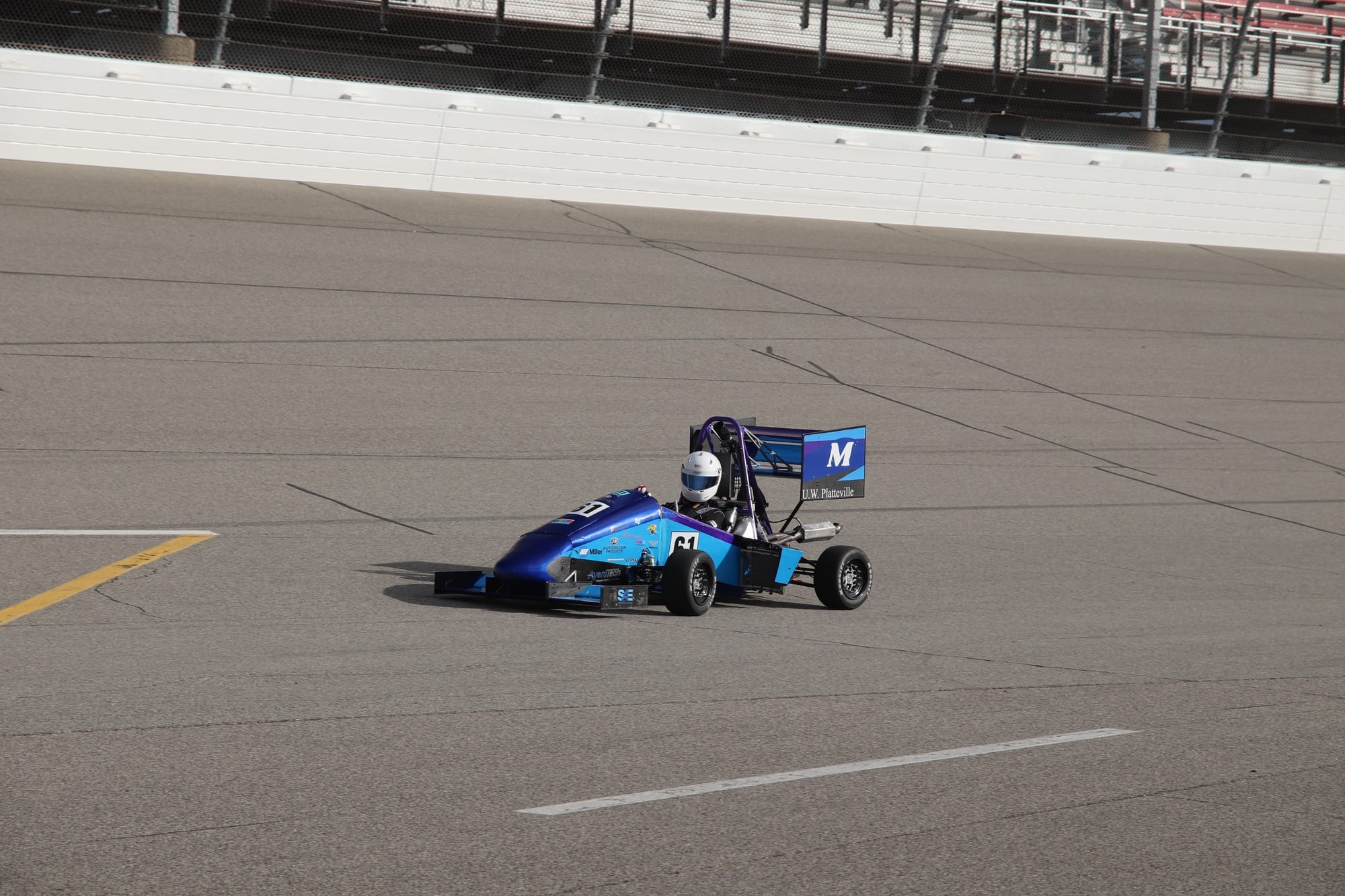 PR26 on track at a competition venue, with U.W. Platteville on the rear wing