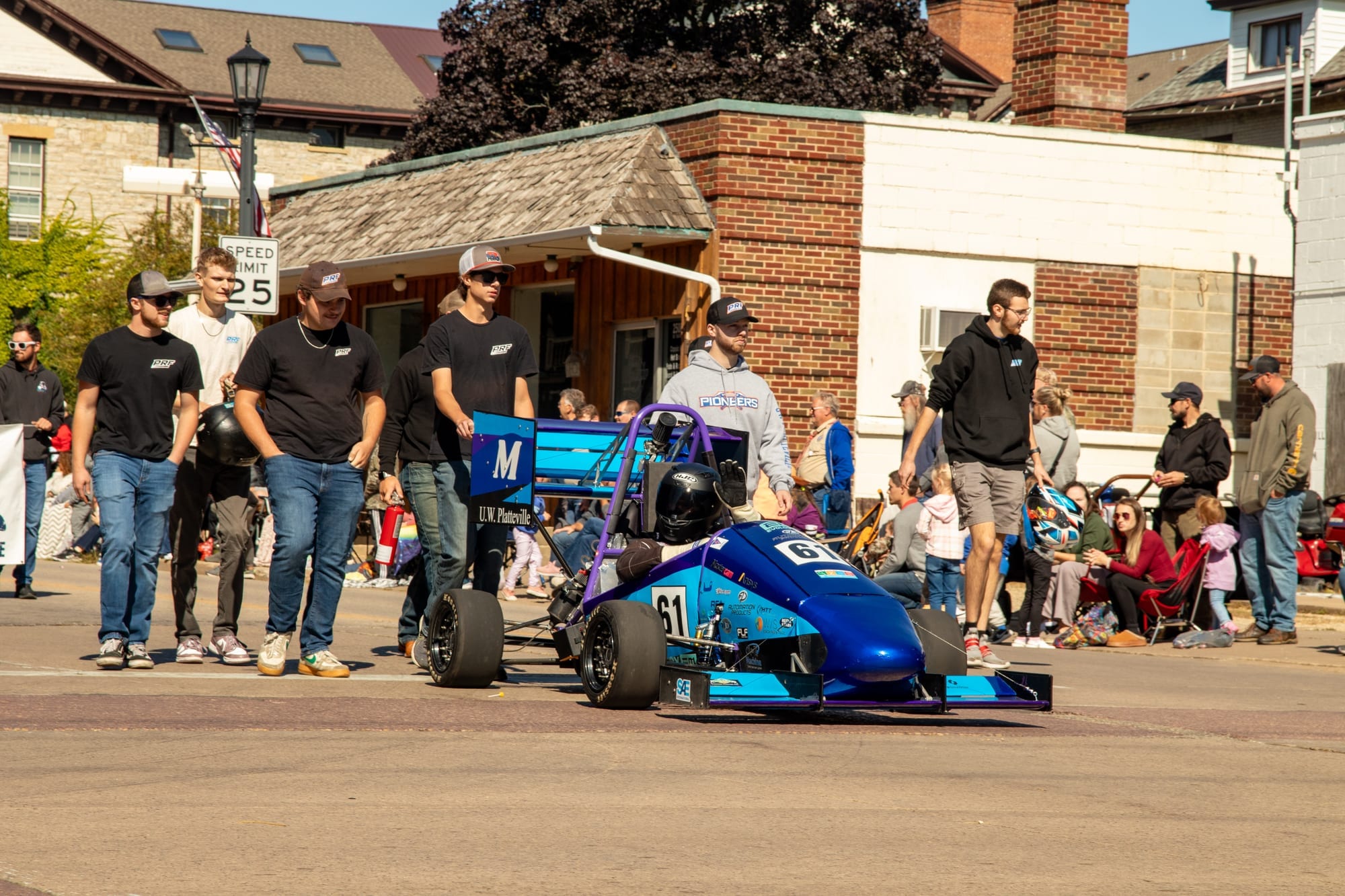 Pioneer Racing walking PR26 through a community parade
