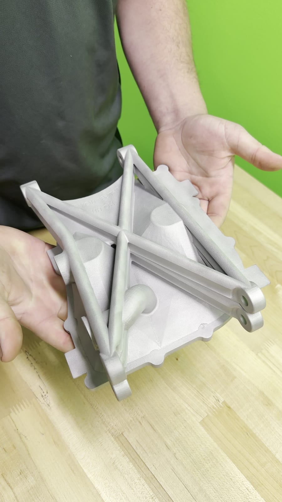 As-printed PR26 oil pan showing structural X-bracing and machinable mounting bosses