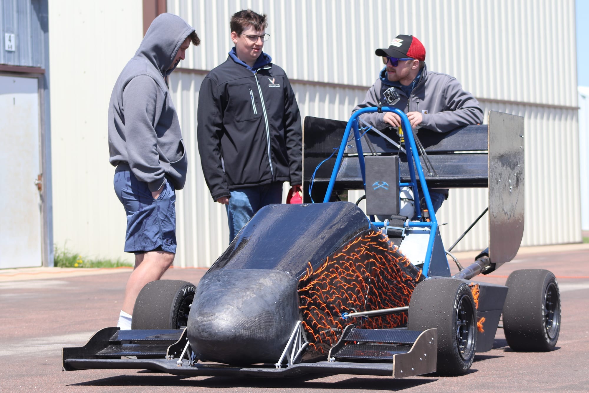 Pioneer Racing students around PR26 during aerodynamic tuft testing