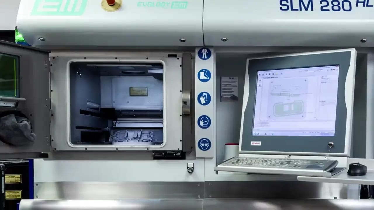 Additive manufacturing machines building metal and polymer parts at Evology